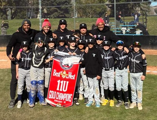 Travail 11U players and coaches holding the Best of the West 11U Gold Champions banner in Kamloops